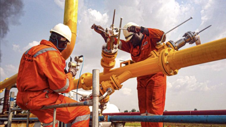 Technicians working on wellhead pipework, Niger Delta
